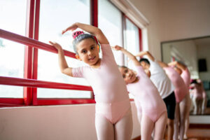 Portrait of ballet dancer stretching during a class at the dance studio